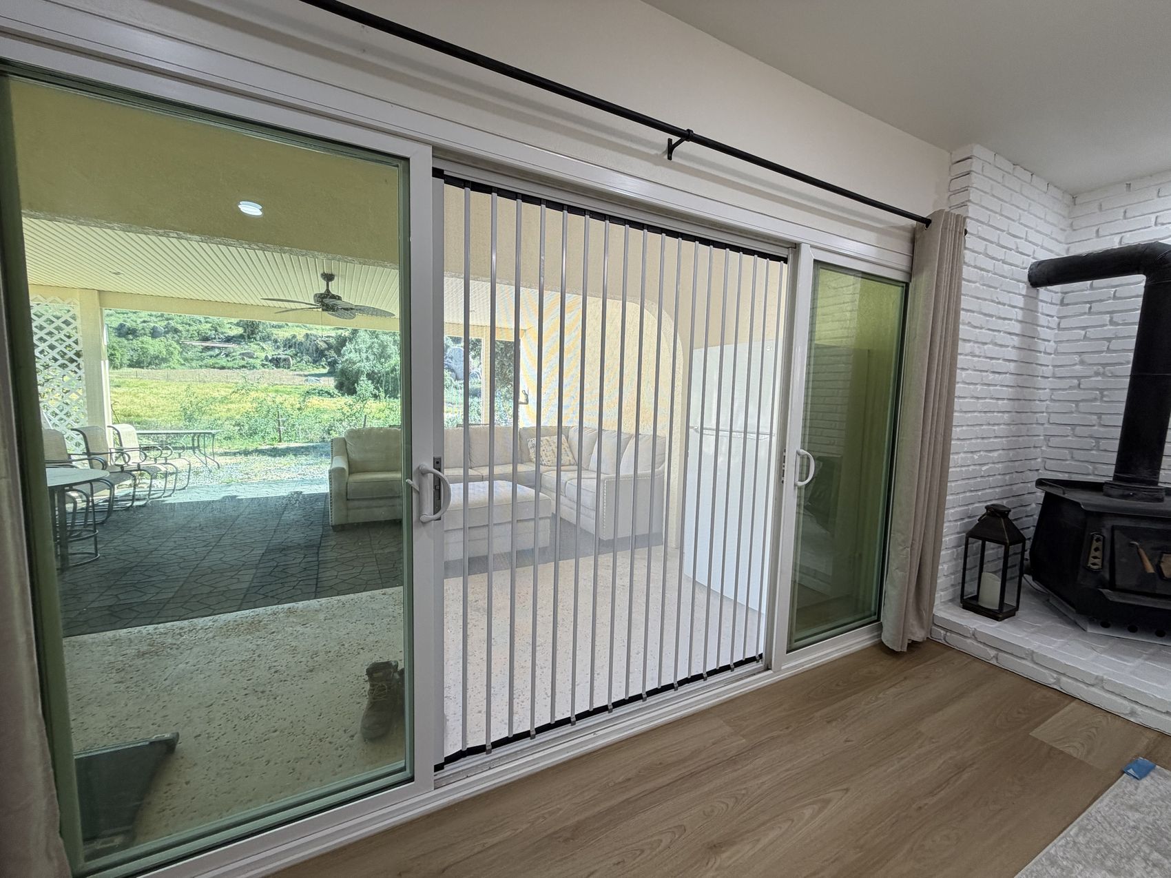 White folding screen in the center panel of a sliding patio door, seen from inside